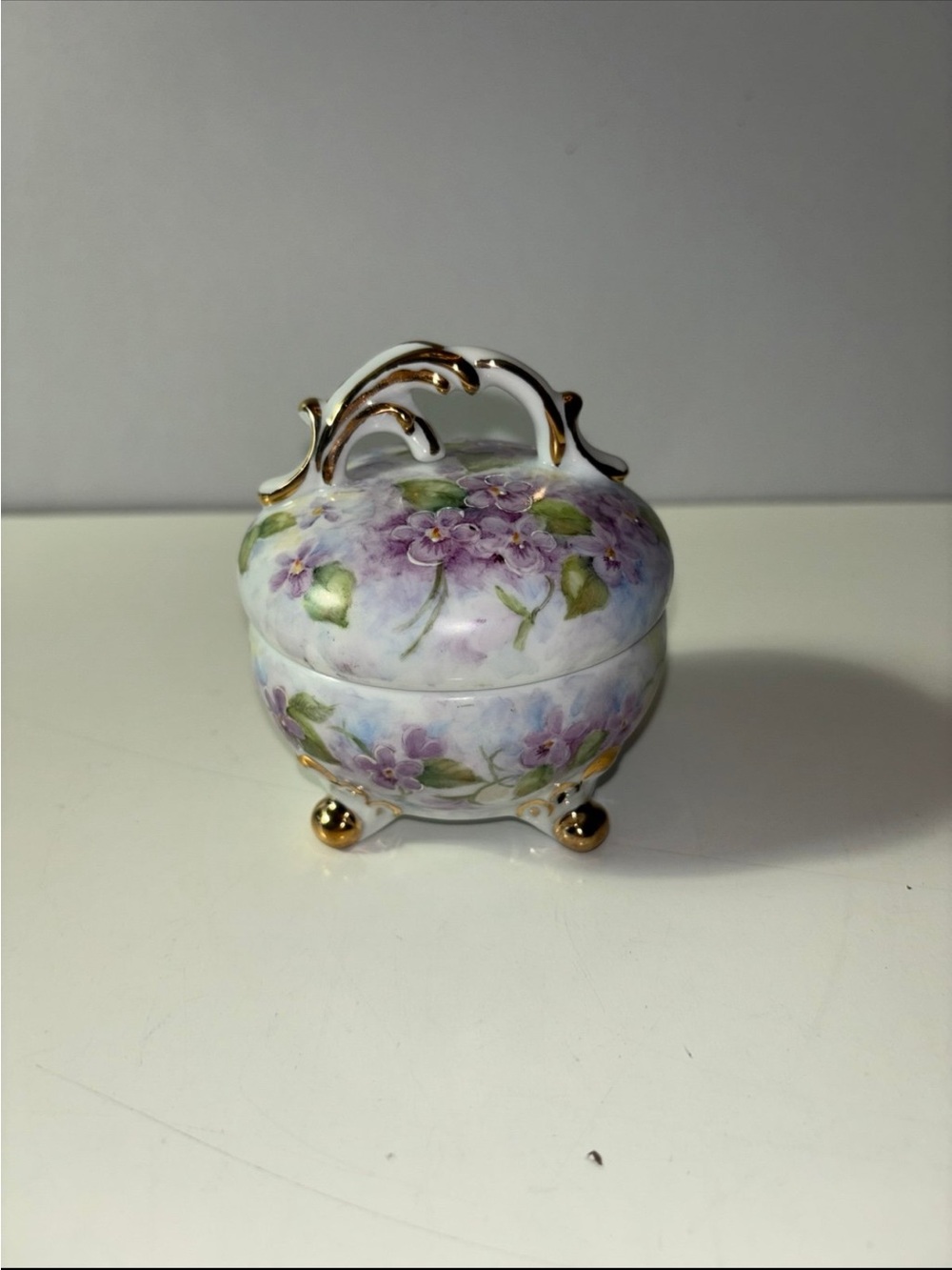 Vintage porcelain or ceramic footed trinket with purple violet floral pattern an